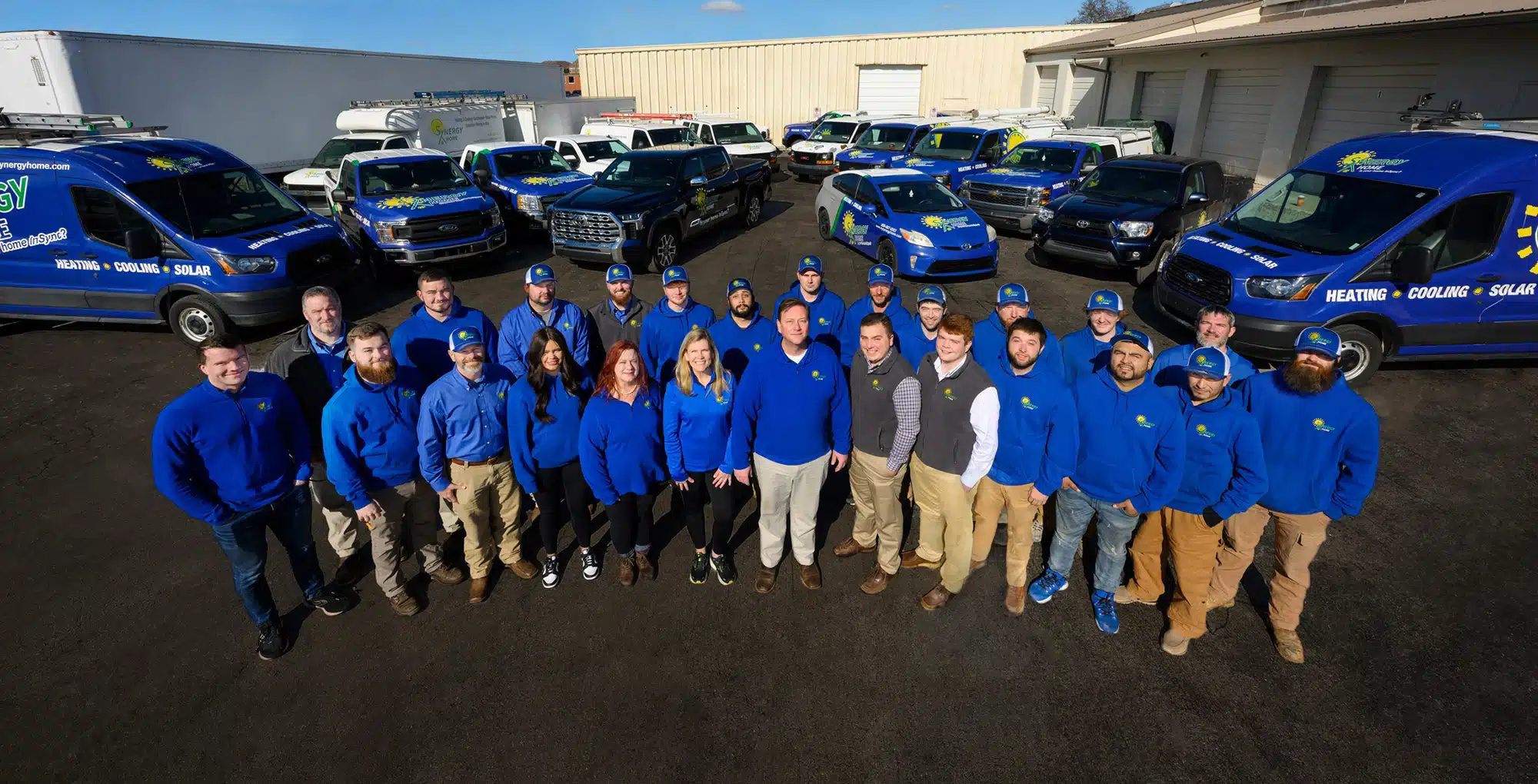 The Synergy Home team in front of their branded service fleet in Lexington, KY